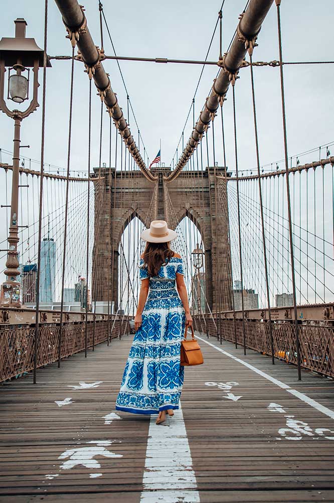 Kristi Hemric (Instagram: @khemric) strolls across the Brooklyn Bridge in New York City