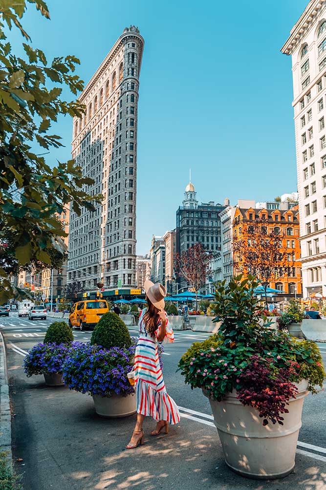 Kristi Hemric (Instagram: @khemric) walks through Madison Square Park in front of the Flatiron Building in NYC