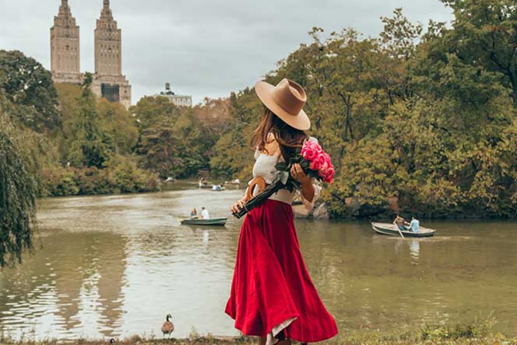 Kristi Hemric (Instagram: @khemric) shows off her flowers during fall at The Lake in Central Park in New York City